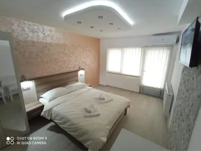 a bedroom with a bed with two towels on it at Studio Dunja in Soko Banja