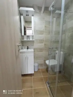 a bathroom with a toilet and a sink and a shower at Studio Dunja in Soko Banja