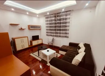 a living room with a couch and a table at Niš Apartment in Niš