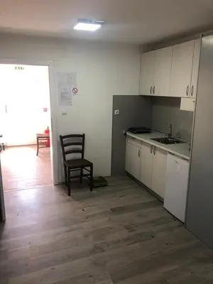 a kitchen with a sink and a chair in a room at Vila Zdravković Prolom Banja in Prolomska Banja