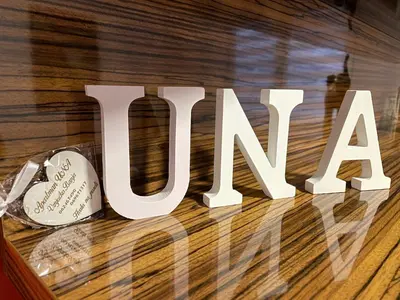 a sign that says love on a wooden table at Una in Vrnjačka Banja