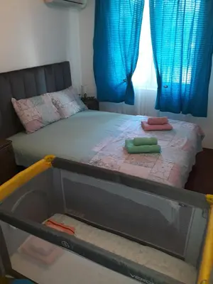 a bed with two towels on it in a bedroom at Una in Vrnjačka Banja