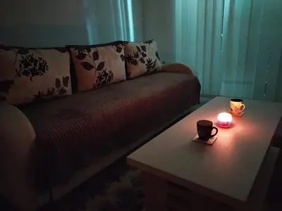 a living room with a couch with a candle on a table at Apartman Todorovic in Jagodina