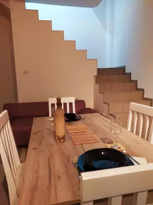 a wooden table with a bottle of wine on it at Apartman Todorovic in Jagodina