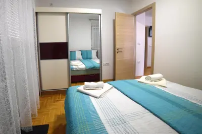 a bedroom with two beds with towels on them at Panoramske Vile in Vrnjačka Banja