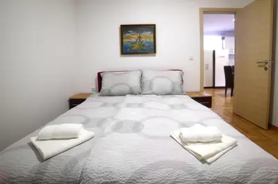 a bedroom with a large bed with two towels on it at Panoramske Vile in Vrnjačka Banja