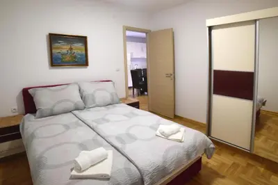 a bedroom with a bed with two towels on it at Panoramske Vile in Vrnjačka Banja