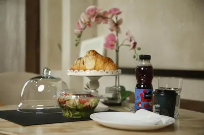a table with a pie and a bowl of salad at Design Apartment GRAND SPA LUX 4 STAR 