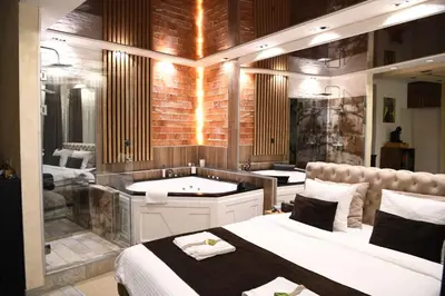 a bathroom with two beds and a bath tub at Design Apartment GRAND SPA LUX 4 STAR 