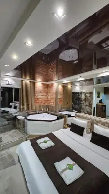a large room with two beds and a bath tub at Design Apartment GRAND SPA LUX 4 STAR 