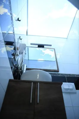 a bathroom with a chair and a computer monitor at Design Apartment GRAND SPA LUX 4 STAR 