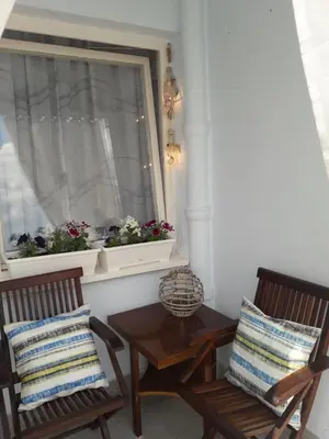 two chairs and a table in front of a window at Kutak- stan na dan in Paraćin