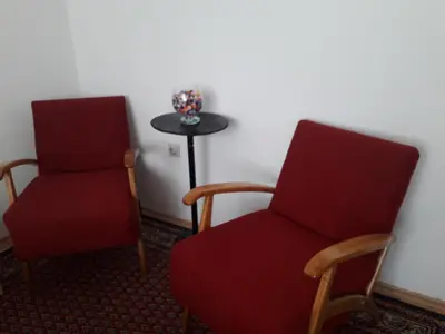 two chairs and a table in a room at Kutak- stan na dan in Paraćin