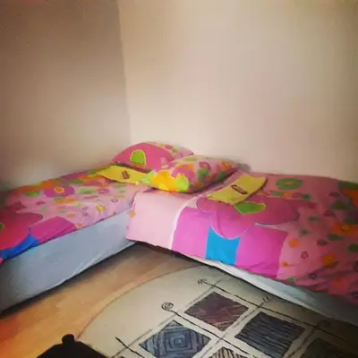 two twin beds in a bedroom with a floor at Kutak- stan na dan in Paraćin