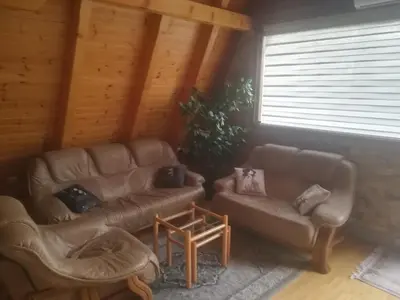a living room with two couches and a table at Banjska brvnara in Vrnjačka Banja