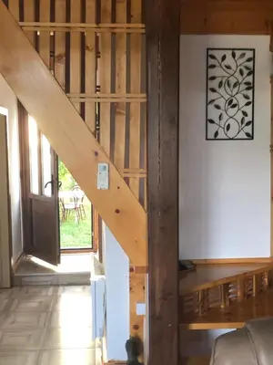 a wooden staircase in a living room with a door at Banjska brvnara in Vrnjačka Banja