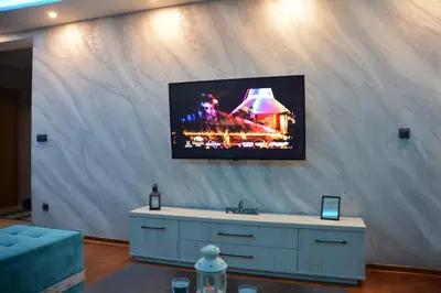 a living room with a tv on a wall at MONA RELAX in Vrnjačka Banja