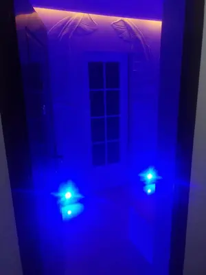 a room with blue lights in a dark room at Apartman Cristallino in Niš