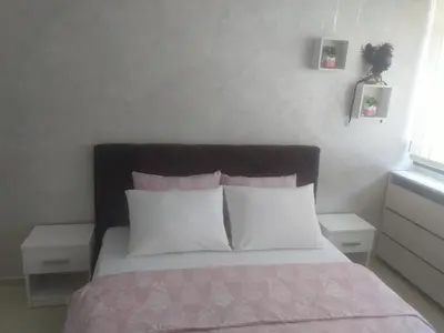 a bedroom with a bed with two white pillows at Apartman Cristallino in Niš