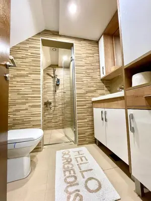 a bathroom with a shower and a toilet and a rug at Casa Nostra Kop in Kopaonik