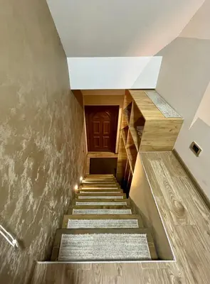 a staircase leading up to a building with a wooden door at Casa Nostra Kop in Kopaonik
