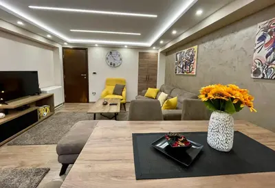 a living room with a couch and a table at Casa Nostra Kop in Kopaonik