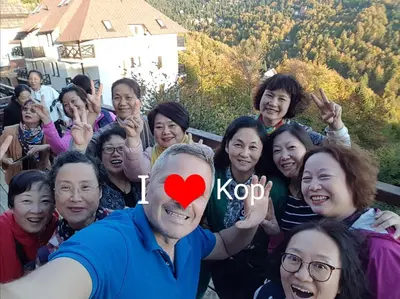 a man with a heart on his face with a group of people at Casa Nostra Kop in Kopaonik