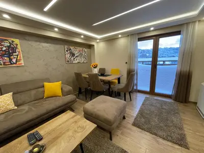 a living room with a couch and a table at Casa Nostra Kop in Kopaonik