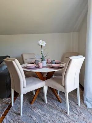 a white dining room table with two chairs at AS Delux Apartmani in Soko Banja