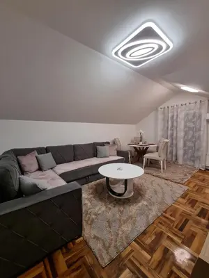 a living room with a couch and a table at AS Delux Apartmani in Soko Banja