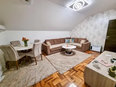 a living room with a couch and a table at AS Delux Apartmani in Soko Banja