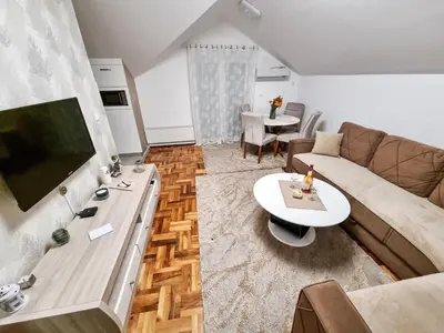 a living room with a couch and a table at AS Delux Apartmani in Soko Banja