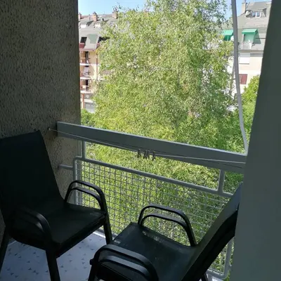 two chairs sitting on a balcony with a window at Apartman Bogdanović Sokobanja in Soko Banja