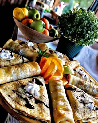 a table with a bunch of bread and fruit at Milosev Konak in Aleksandrovac