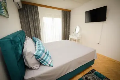 a bedroom with a bed and a television in it at Apartman NINA in Vrnjačka Banja