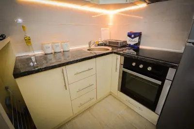 a small kitchen with a sink and a stove at Apartman NINA in Vrnjačka Banja