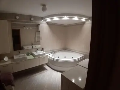 a large bathroom with a tub and two sinks at Brown Apartment - Niš Center in Niš