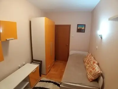 a small room with a couch and a cabinet at Brown Apartment - Niš Center in Niš