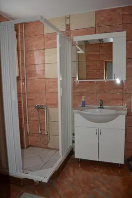 a bathroom with a shower and a sink at LIRA EXCELLENT NIS in Niš