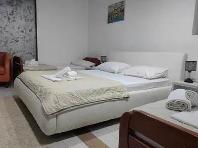 a bedroom with two beds with towels on them at LIRA EXCELLENT NIS in Niš