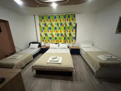 a room with two beds and a window at LIRA EXCELLENT NIS in Niš