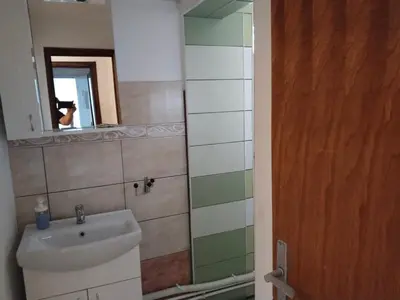 a bathroom with a sink and a mirror at LIRA EXCELLENT NIS in Niš