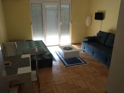 a living room with a couch and a table at Studio BV in Vrnjačka Banja