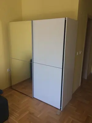 a white refrigerator in a room with wooden floors at Studio BV in Vrnjačka Banja