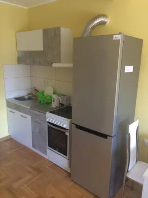 a kitchen with a stainless steel refrigerator and a stove at Studio BV in Vrnjačka Banja