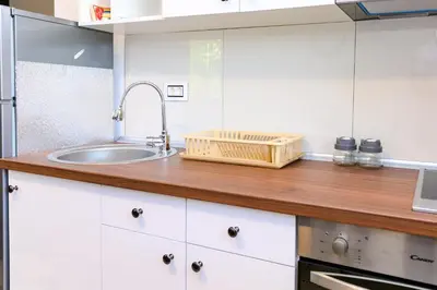 a kitchen with a sink and a wooden counter top at Apartman N&P in Soko Banja
