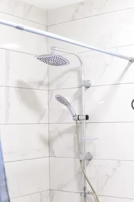 a shower with a shower head in a bathroom at Apartman N&P in Soko Banja