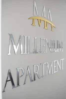 a sign that reads a million dollar restaurant and a sign that says a million premier at Millenium apartment in Soko Banja