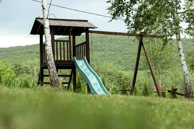 a playground with a slide and a gazebo at Miletic Villas in Despotovac