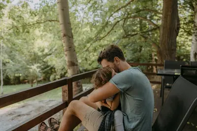 a man and a woman sitting on a fence at Miletic Villas in Despotovac